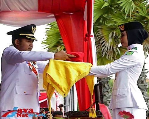 Bupati Sumenep Ra Achmad Fauzi SH MH saat menyerahkan Bendera Pusaka Merah Putih Kepada Anggota Paskibraka