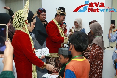 Bupati Sumenep Achmad Fauzi Wongsojudo Bersama Istri Nia Kurnia Fauzi Saat Memberikan Santunan 754 Anak Yatim di Acara Prosesi Peringatan Hari Jadi Kabupaten Sumenep ke-754, Sabtu (28/10/2023) di Kota Tua Kalianget